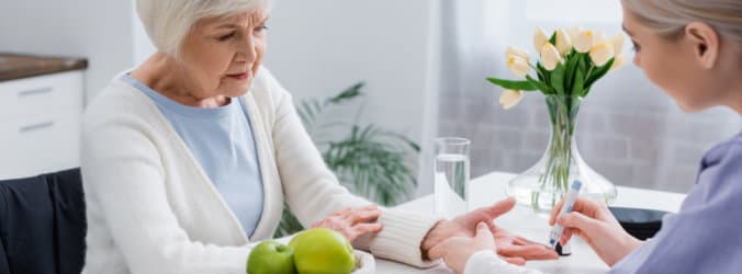 a caregiver assisting senior woman